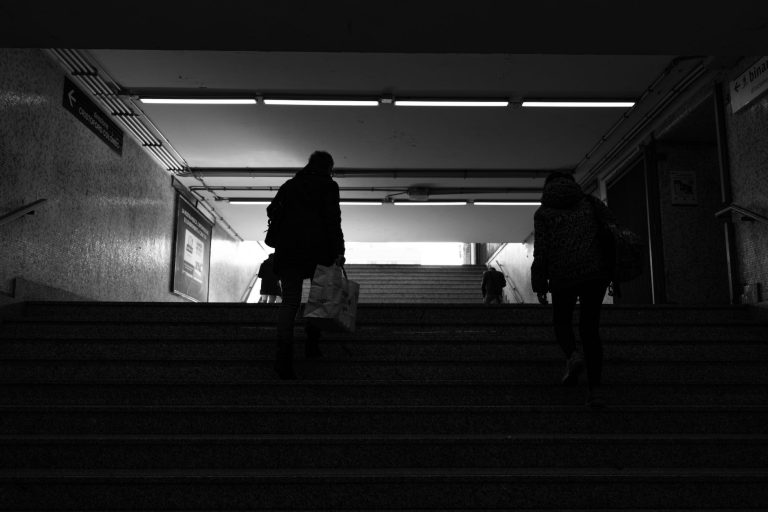 passengers climbing stairs in underground station
